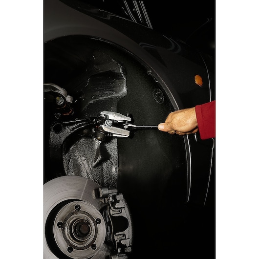 Facom U_16A45 automotive tool in use, removing a tie rod end from a car suspension.