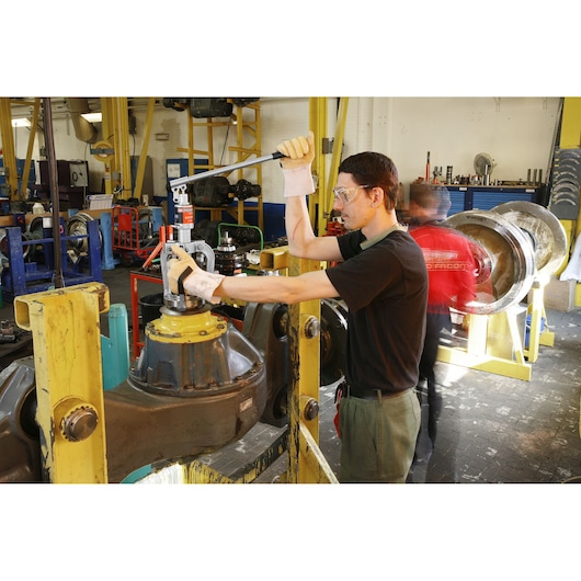 Photo of Facom U312H torque wrench in use for assembly in an industrial workshop setting.