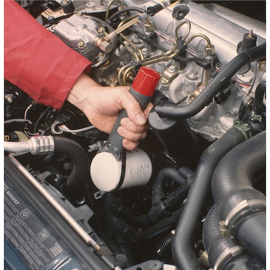 Facom oil filter wrench U_46ACL used on a car engine in close-up photography.