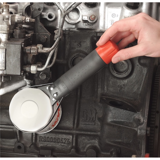 Facom U_46ACL oil filter wrench with black and red handle used on engine component.