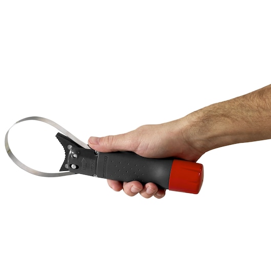 Photo of Facom U_46ACL adjustable oil filter wrench with black handle and red cap, held in hand, side view.