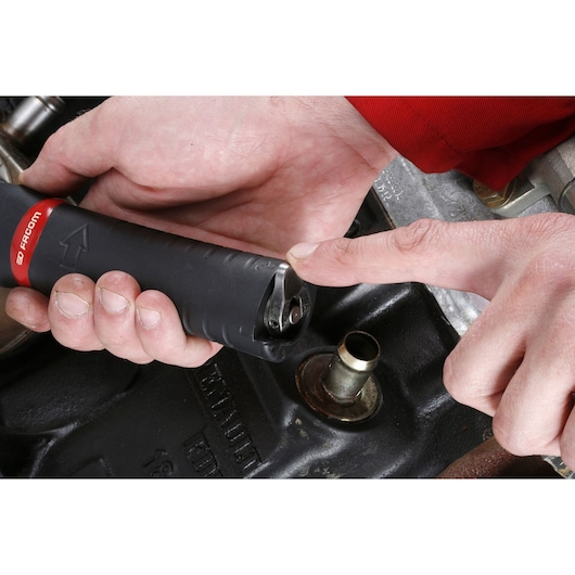 Photo of Facom U_48PL tool handle with hand showing tip detail, used for automotive work.