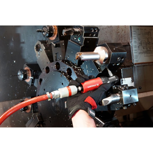 Facom VR.R127PB pneumatic tool in use near lathe machine, red and black handle, close-up photography.