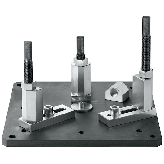Facom W_400SUP photography of metal clamping kit with threaded bolts and blocks on black base, front angle.
